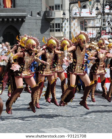 ALCOY, SPAIN - MAY 14: Women wearing dragon costumes performing dance in annual Alcoy Moros y Cristianos celebration parade commemorating 8th-15th century battles in Spain. Alcoy May 14, 2011.