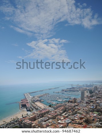 ALICANTE, SPAIN - APR 28: Alicant harbor (natural / artificial) has restaurants, shops, bars and beach to its left. Annually cruise ships bring over 100,000 tourists and crew to Alicante. Apr 28, 2011