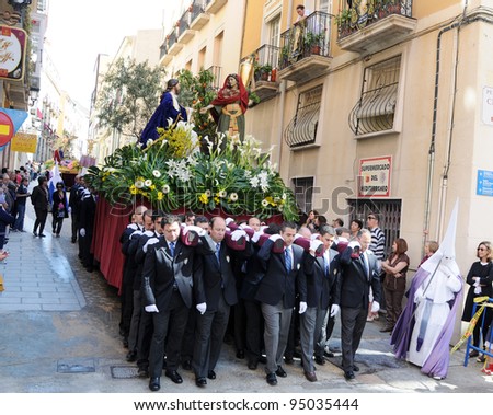 ALICANTE, SPAIN - APR 17: Semana Santa Palm Sunday religious celebration procession of brotherhood carrying \