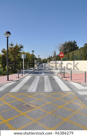 Pedestrian Crosswalk Wrong Way Traffic Sign on Modern Mediterranean Suburban Neighborhood Street in Spain Europe