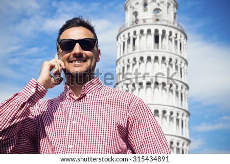 The young handsome man make a conversation near the tower in Italy