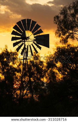 Country Windmill Silhouette with orange sky sunset