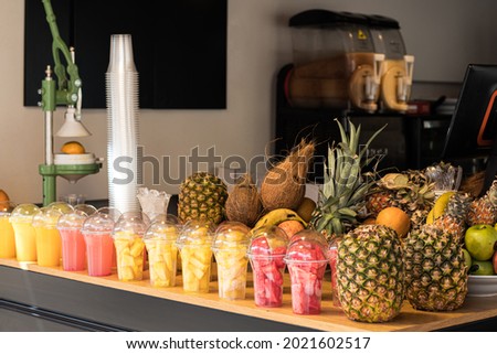 Tropical exotic organic fruits pineapple, apple, banana, coconut, watermelon, milkshake, juice at the local store, shop, market place. Fruit background. Fresh fruit juice. Sliced fruit. Fruit juice.