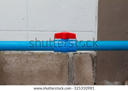 leaking water from blue pipe and red valve