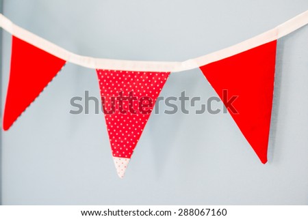 Stretching from three red  flags hanging on a blue background. Marine decorations