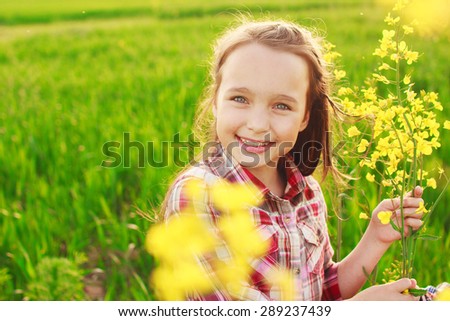 little girl in the field with flowers. portrait