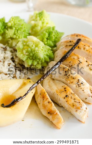 Chicken fillet in vanilla sauce with pears served with rice and cauliflowers