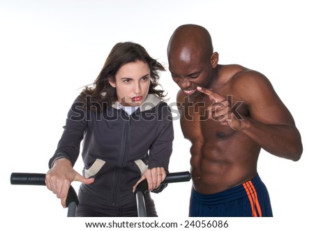 Young adult woman working out as personal trainer encourage her to try harder.