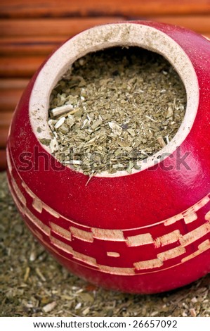 Close up of calabash cup with spill of yerba mate tea. Use of Selective Focus.