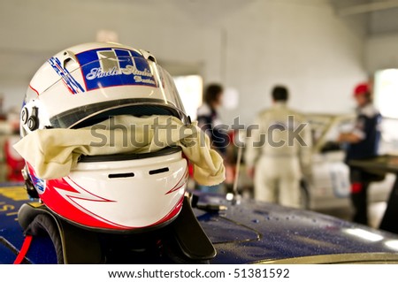 MIAMI - APRIL 18: Close up of a racing helmet in the boxes during FARA Races with drivers in background, April 18, 2010 in Miami, Florida.