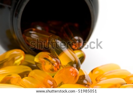 Close up view of Omega 3 pills, spilling from bottle. Use of selective focus.