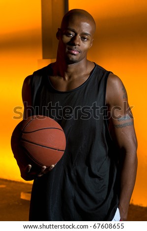Basketball player at night, in the street.