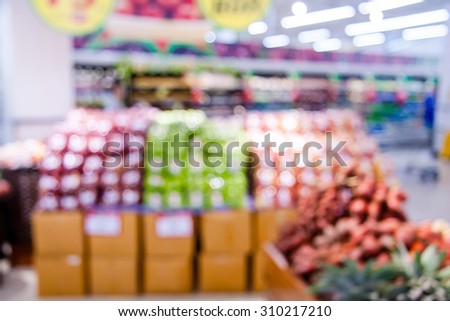 Shopping blur in the super market.\
The corridor filled with fruits, vegetables and other products. And products on the shelves in supermarkets.