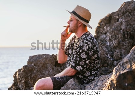 Similar – Image, Stock Photo Adult man smoking cannabis joint