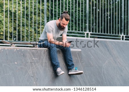 Similar – Image, Stock Photo Carefree male skater browsing cellphone in city