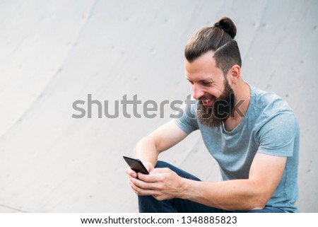 Similar – Image, Stock Photo Carefree male skater browsing cellphone in city