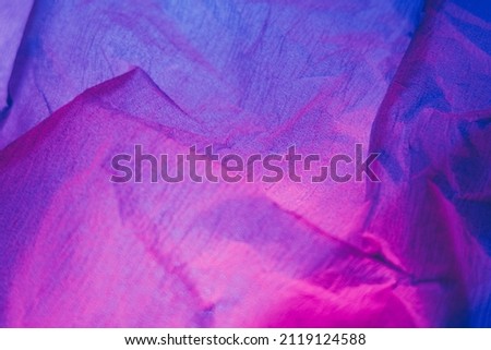 Creased paper texture. Ultraviolet background. Crushed material. Neon iridescent pink purple blue color gradient light grain noise wrinkled abstract surface. Foto stock © 