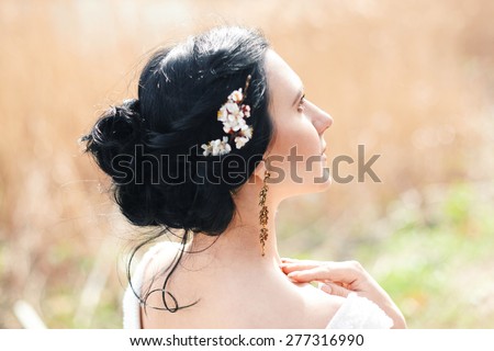 the gentle bride with spring flowers in a hairstyle