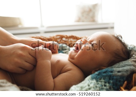 Similar – Image, Stock Photo Lovely and curious newborn lying down in her little bed