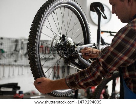 Similar – Foto Bild Crop Mechaniker Befestigung Fahrrad Rad mit Steckschlüssel