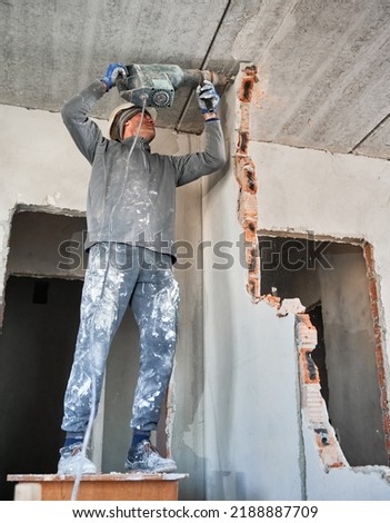 Similar – Image, Stock Photo Man worker drilling wall with hammer drill, top view