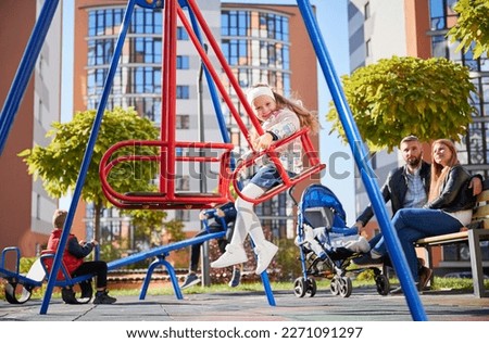 Similar – Image, Stock Photo Joyful couple on playground against grassy field