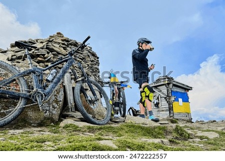 Similar – Image, Stock Photo man resting while riding a bicycle on a mountain road