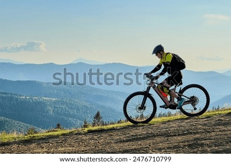 Similar – Image, Stock Photo healthy man riding a bicycle on a mountain road in a sunny day