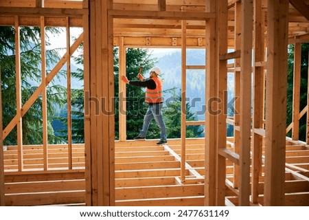 Image, Stock Photo Builders at work with wooden roof construction.