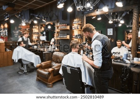 Similar – Image, Stock Photo View of a barber shop from outside the enclosure with a barber inside cutting a client’s hair