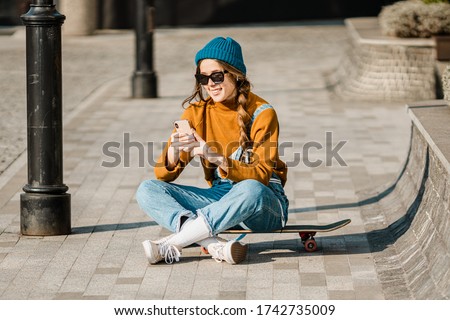 Similar – Image, Stock Photo Hipster skater sitting on skateboard near ramp