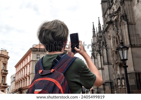 Similar – Image, Stock Photo Man shooting building facade with smartphone in downtown