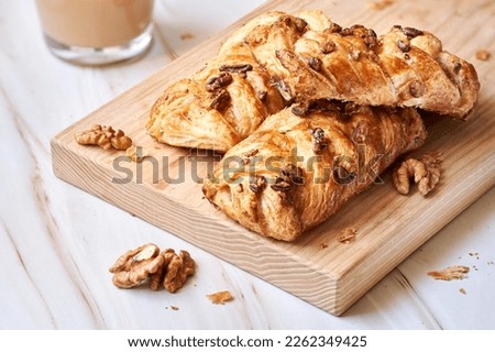 Pecan and walnut plait pastry filled with maple sirup on wooden board Stock foto © 