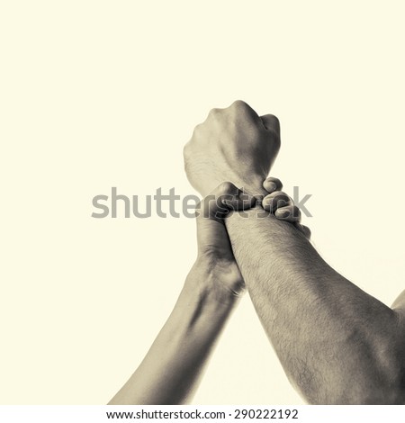 woman\'s hand gripping a man\'s fist stopping aggression
