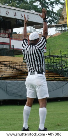 Football referee signaling touchdown