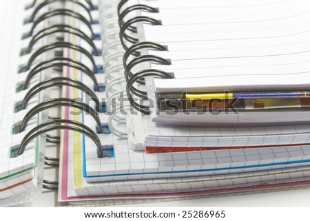 Three opened notebooks with with black and white spiral