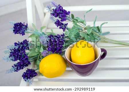 Still life with fresh lemons and lavender on a white chair top view