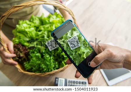 Customers buy organic vegetables from hydroponics farm and pay using QR code scanning system payment at food market shop. Technology and futuristic business. E wallet and digital cashless concept Photo stock © 