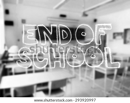 A chalk lettering with a blurred classroom in the background - black and white photography.