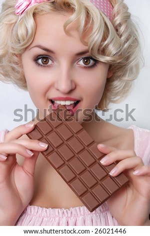 young blond woman eating chocolate