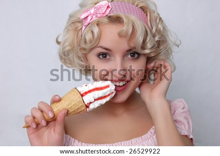 young blond woman starting to eat ice cream