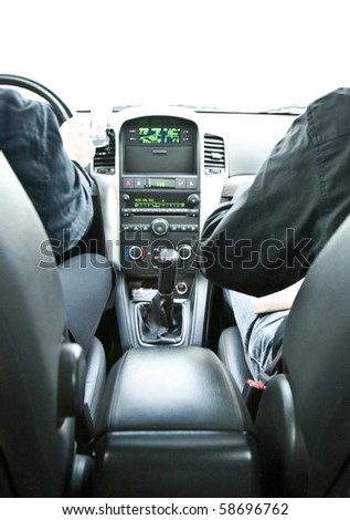 two persons hand in black dressed in luxury car driving with control panel
