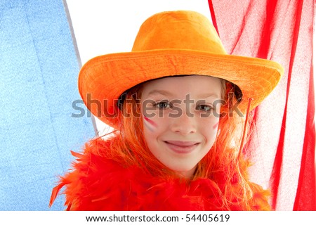 Young Dutch soccer supporter in orange outfit against the Netherlands flag
