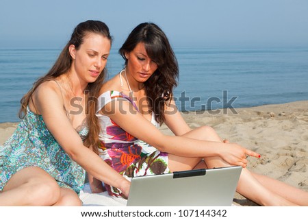 Two Women with Computer at Seaside