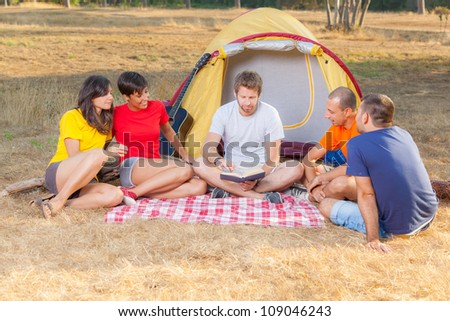 Group of People Camping and Reading a Story