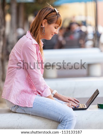 Beautiful Young Woman with Computer Outside