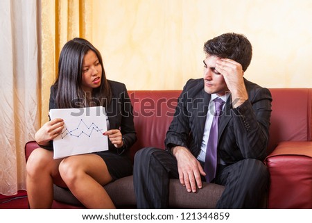 Sad Business Couple on the Sofa