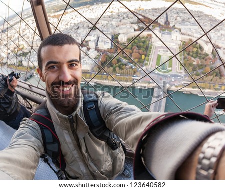 Young Man on the top of Tour Eiffel in Paris
