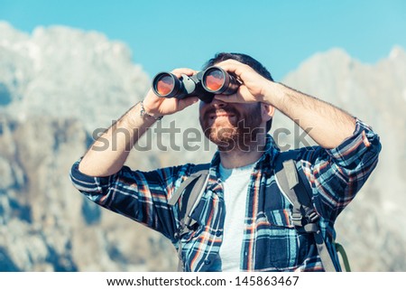 Young Man with Binocular at Mountain