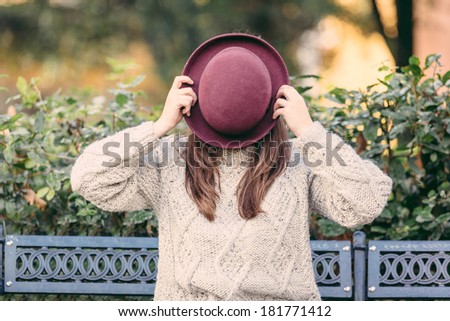 Old Fashioned Woman Hiding Behind Hat